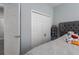This bedroom features a gray upholstered headboard, soft carpet, and a closet at 16161 61St E Ln, Parrish, FL 34219