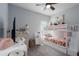 Bright bedroom with bunkbeds, a ceiling fan, and a white desk at 16161 61St E Ln, Parrish, FL 34219