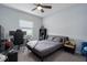 This bedroom features a ceiling fan, soft carpet, and natural light at 16161 61St E Ln, Parrish, FL 34219