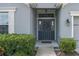 Inviting front entryway with a decorative wreath and manicured shrubs at 16161 61St E Ln, Parrish, FL 34219