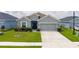 Charming single-story home with a well-manicured lawn and a two-car garage at 16161 61St E Ln, Parrish, FL 34219