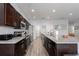 Modern kitchen with stainless appliances, dark wood cabinets and granite counters at 16161 61St E Ln, Parrish, FL 34219