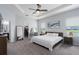 Spacious main bedroom features a tray ceiling, plush carpet, and a view of the water at 16161 61St E Ln, Parrish, FL 34219