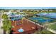 A colorful playground and recreational area adjacent to well-kept tennis courts, perfect for families at 16161 61St E Ln, Parrish, FL 34219