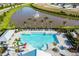 Aerial view of a stunning community pool, with a fountain pond backdrop and ample lounging at 16161 61St E Ln, Parrish, FL 34219