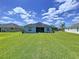 Spacious backyard featuring lush green lawn and a screened-in lanai, perfect for outdoor living at 16848 Rosedown Gln, Parrish, FL 34219