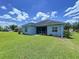 Well-maintained home exterior with a screened lanai and lush backyard landscaping at 16848 Rosedown Gln, Parrish, FL 34219
