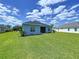Spacious backyard showcasing well-maintained lawn, beautiful landscaping, and screened lanai at 16848 Rosedown Gln, Parrish, FL 34219