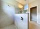 Bathroom featuring a walk-in shower with tiled walls and a glass partition at 16848 Rosedown Gln, Parrish, FL 34219