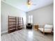 Bedroom with a wood-look floor, a ceiling fan, a shuttered window and natural wood shelves at 16848 Rosedown Gln, Parrish, FL 34219
