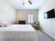 Comfortable bedroom featuring a queen-sized bed, a chair, a dresser, and a window at 16848 Rosedown Gln, Parrish, FL 34219