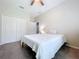 Bright bedroom featuring a ceiling fan, closet and a neatly made bed, creating a serene atmosphere at 16848 Rosedown Gln, Parrish, FL 34219