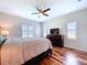 Bright bedroom features hardwood floors, ceiling fan, dresser and large windows at 16848 Rosedown Gln, Parrish, FL 34219