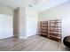 Well-lit bedroom featuring wood floors, double closets, a ceiling fan, and neutral walls at 16848 Rosedown Gln, Parrish, FL 34219