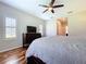 Comfortable bedroom showcases hardwood floors and natural light from shuttered windows at 16848 Rosedown Gln, Parrish, FL 34219
