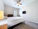 Cozy bedroom featuring a queen bed, neutral decor, and a window with plantation shutters at 16848 Rosedown Gln, Parrish, FL 34219