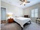 Neutral bedroom featuring a ceiling fan, window with shutters, bedside table, and soft carpet at 16848 Rosedown Gln, Parrish, FL 34219