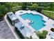 Community pool with ample seating and lush landscaping, perfect for relaxation and recreation at 16848 Rosedown Gln, Parrish, FL 34219
