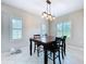 Bright dining room with a wooden table, four chairs, and lots of natural light through the windows at 16848 Rosedown Gln, Parrish, FL 34219
