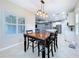 Dining room with a wooden table and chairs, open to the kitchen and living area at 16848 Rosedown Gln, Parrish, FL 34219