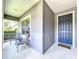 Inviting front porch with seating area and a stylish blue front door at 16848 Rosedown Gln, Parrish, FL 34219