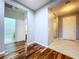 Hallway featuring hardwood and tile flooring, leading to bedrooms and bathrooms at 16848 Rosedown Gln, Parrish, FL 34219