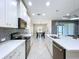 Bright kitchen with white cabinets, stainless steel appliances, and a view of the dining area at 16848 Rosedown Gln, Parrish, FL 34219