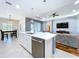 Open concept kitchen with white countertops, stainless steel appliances, and an island with a sink at 16848 Rosedown Gln, Parrish, FL 34219