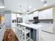 Modern kitchen with white cabinets, stainless steel appliances, and a large center island at 16848 Rosedown Gln, Parrish, FL 34219