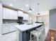 Stylish kitchen featuring white cabinets, stainless appliances, and a spacious island with seating at 16848 Rosedown Gln, Parrish, FL 34219