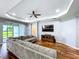 Bright living room with a tray ceiling, hardwood floors, and a sliding glass door to the outdoors at 16848 Rosedown Gln, Parrish, FL 34219