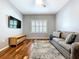 Cozy living room featuring hardwood floors, neutral walls, and a comfortable sofa at 16848 Rosedown Gln, Parrish, FL 34219