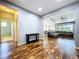 Open-concept living space with hardwood floors, leading to a kitchen and living area at 16848 Rosedown Gln, Parrish, FL 34219