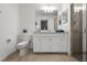 Bright bathroom features a white vanity, large mirror, and glass-enclosed shower at 17902 Gawthrop Dr # 107, Bradenton, FL 34211