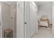 A view of a neutral bathroom, featuring the glass shower stall, white cabinets and neutral bedroom at 17902 Gawthrop Dr # 107, Bradenton, FL 34211