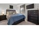 Well-lit bedroom with a mounted TV and dark wood furniture set at 17902 Gawthrop Dr # 107, Bradenton, FL 34211