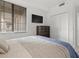 Bedroom featuring a large window, a flat-screen TV, and a double closet at 17902 Gawthrop Dr # 107, Bradenton, FL 34211
