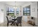 Bright breakfast nook features a round table, gray chairs, and natural light streaming through large windows with scenic views at 17902 Gawthrop Dr # 107, Bradenton, FL 34211