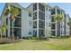 Beautiful condo exterior with screened balconies and tropical landscaping in a golf course community at 17902 Gawthrop Dr # 107, Bradenton, FL 34211