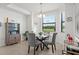 Dining room features a round table with seating for four near a window with a view at 17902 Gawthrop Dr # 107, Bradenton, FL 34211