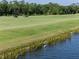 Scenic golf course view with pond and wildlife, offering a tranquil and picturesque setting at 17902 Gawthrop Dr # 107, Bradenton, FL 34211