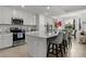 Bright kitchen features white cabinets, stainless steel appliances, and a spacious island with barstool seating at 17902 Gawthrop Dr # 107, Bradenton, FL 34211