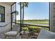 Relaxing screened-in lanai with comfortable seating overlooking a golf course at 17902 Gawthrop Dr # 107, Bradenton, FL 34211