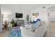 Open-concept living room features a comfortable sofa, blue accent chair, mounted TV, and stylish decor at 17902 Gawthrop Dr # 107, Bradenton, FL 34211