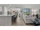 Living room features a neutral palette, large window, and seamless transition to the kitchen and dining area at 17902 Gawthrop Dr # 107, Bradenton, FL 34211