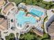 Aerial view of a resort-style pool with a splash pad, a lazy river, and ample lounging chairs at 17902 Gawthrop Dr # 107, Bradenton, FL 34211