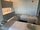 Inviting spa room with two massage beds, sink, and cabinet perfect for relaxation and rejuvenation at 17902 Gawthrop Dr # 107, Bradenton, FL 34211