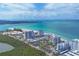 Breathtaking aerial showcasing white beachfront condos, tennis courts and expansive ocean views at 1800 Benjamin Franklin Dr # B310, Sarasota, FL 34236