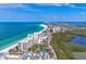 Stunning aerial view of beachfront condos with white sand beaches and turquoise water at 1800 Benjamin Franklin Dr # B310, Sarasota, FL 34236
