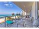 Large balcony overlooking beach with lounge chairs and ocean views at 1800 Benjamin Franklin Dr # B310, Sarasota, FL 34236